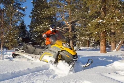 Athlete on a snowmobile. Stock Photos