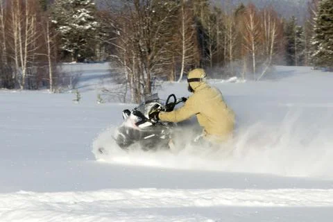 Athlete on a snowmobile. Stock Photos