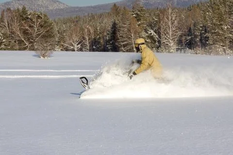 Athlete on a snowmobile Stock Photos