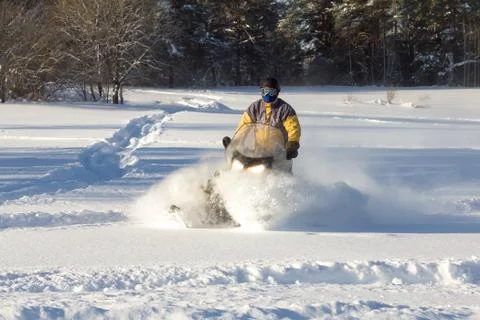 Athlete on a snowmobile. Stock Photos