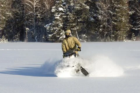 Athlete on a snowmobile. Stock Photos