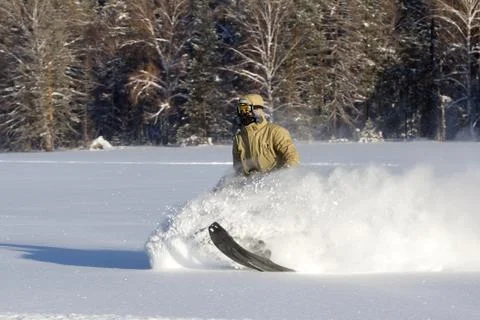 Athlete on a snowmobile. Stock Photos
