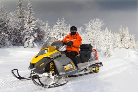 Athlete on a snowmobile. Stock Photos