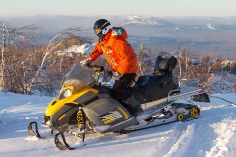 Athlete on a snowmobile. Stock Photos