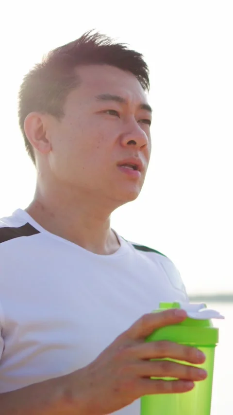An Athlete Staying Hydrated During a Challenging Outdoor Training Session in Stock Footage 314151463