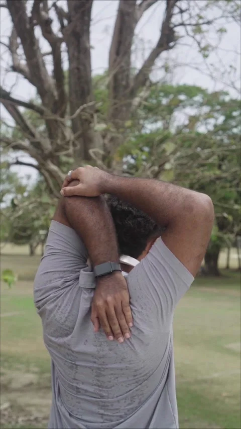 Athlete stretching arms and back during outdoor workout Video stock 344881814