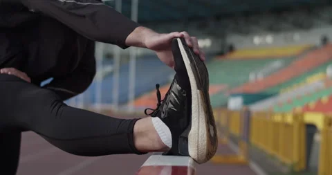 Athlete stretching before training on stadium 스톡 동영상 199646964