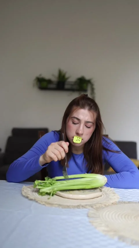 Athlete struggles to eat plain celery Stock Footage 339854903