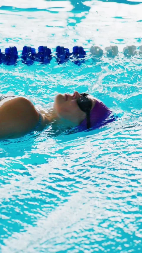 Athlete swims freestyle in bright pool Stock Footage 346457688