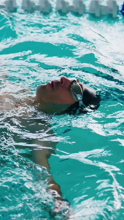 Athlete swims freestyle in bright pool lanes Stock Footage 346457880