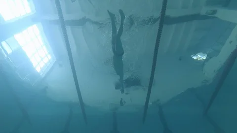 Athlete swims in the pool. the view from the bottom Stock Footage 85511442
