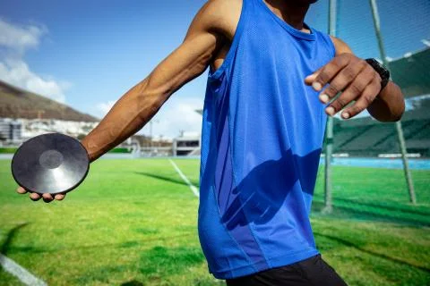 Athlete throwing a disc in a stadium Stock Photos