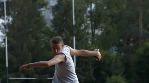 Athlete throwing discus training on a field for olimpics Stock Footage 64011913