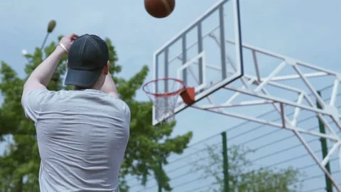 The athlete throws the ball in the ring on a basketball field Stock Footage 108099326