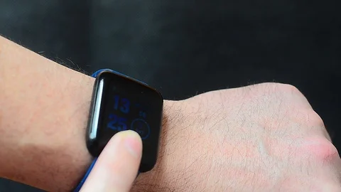 The athlete touches the touch button of the smart watch . Video stock 126375061