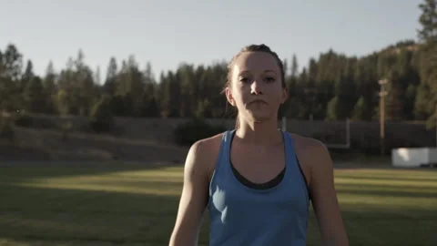 Athlete training with weight ball on field during sunset workout session Stock Footage 312724072