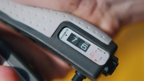Athlete uses an hand expander. Guy trains sitting at stadium Video stock 260829543