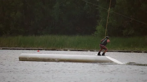 Athlete wakeboarder jumping on trampolines Stock Footage 64363477