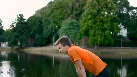 Athlete walking back and forth in the park tired after heavy workout training 스톡 동영상 93306002