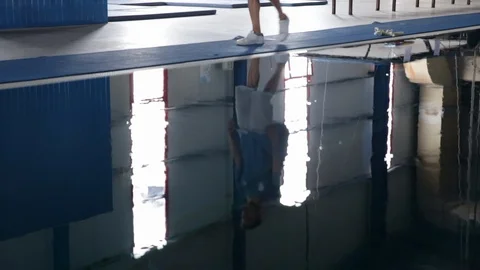 Athlete walking by the pool 스톡 동영상 86995207