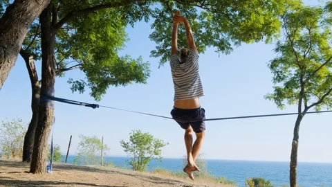 Athlete walking in slackline Stock Footage 121286744