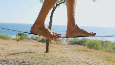 Athlete walking in slackline Stock Footage 121287172