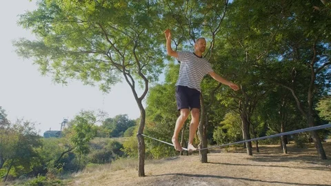 Athlete walking in slackline Stock Footage 121287205