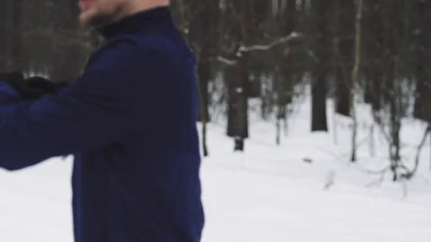 Athlete warms up before Jogging in the woods in winter. 4K 50 Stock Footage 124782873