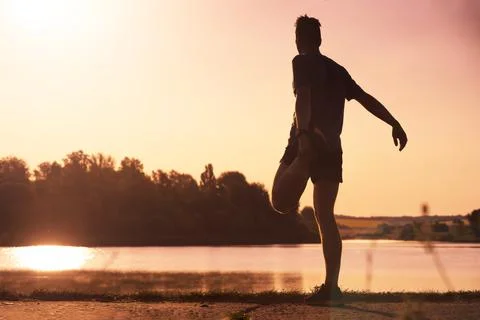 The athlete warms up before running. Stock Photos