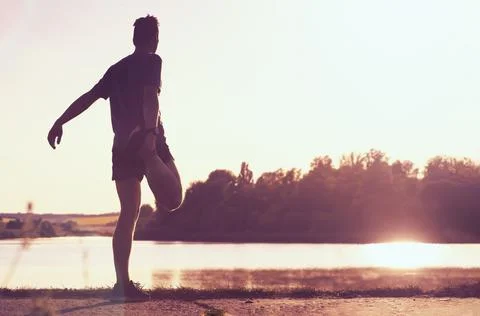 The athlete warms up before running. Stock Photos