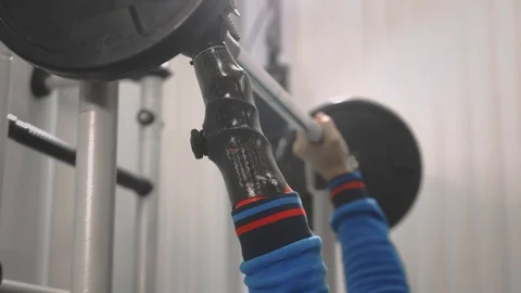An athlete without a hand raises the barbell while lying down. Holds the bar Stock Footage 123225944