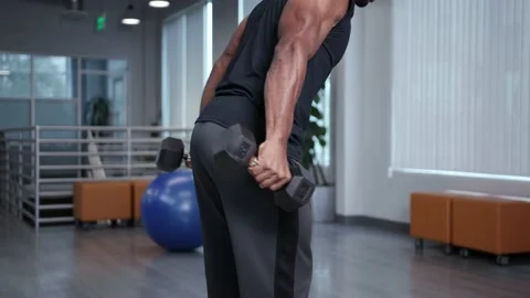 Athlete working out with free weights at home Stock Footage 133536500
