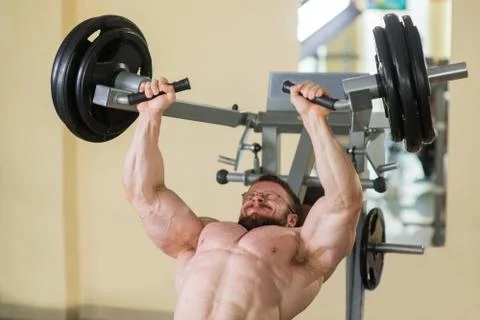 Athlete working out in gym. Stock Photos