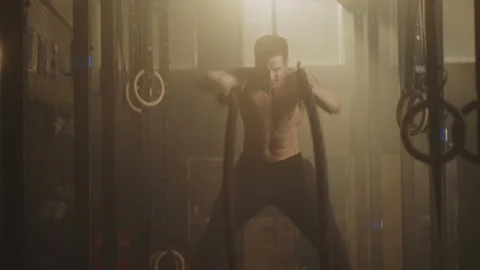 Athlete working out using battle ropes Stock Footage 236184738