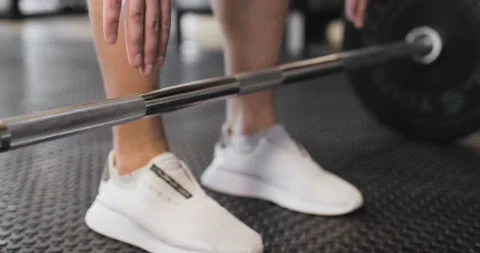 Athlete's approach to the bar. Partial view of powerlifter in white sneakers Stock Footage 158760179
