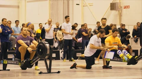Athletes are rowing on a rowing machine Stock Footage 58031793