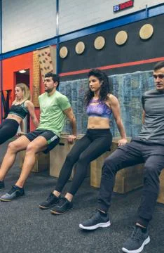 Athletes exercising doing box squats Stock Photos