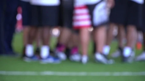 Athletes in huddle - ground level 스톡 동영상 77354081