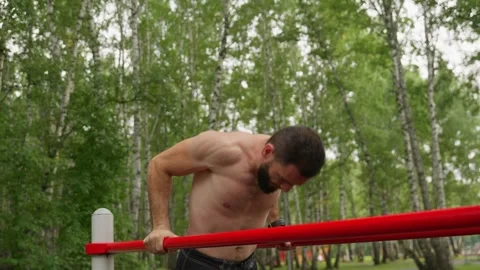 Athlete's Outdoor Strength Training on Parallel Bars Stock Footage 329599224