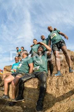 Athletes overcoming the hay osbtacle Stock Photos