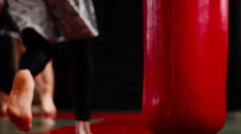 Athletes run and warm up before training. Red punching bag hang in training room Stock Footage 59085290