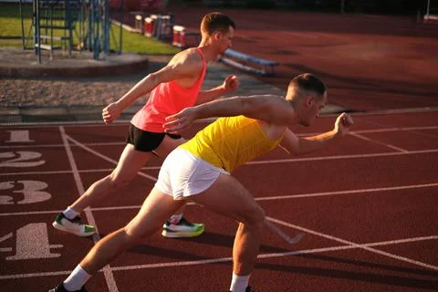Athletes run in the stadium preparing for competitions Stock Photos