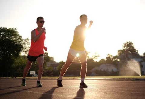 Athletes run in the stadium preparing for competitions Stock Photos