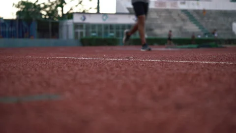 Athletes run on a treadmill at the stadium. Bottom view, feet in the frame. Stock Footage 170580903