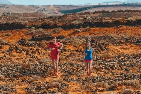 Athletes runners trail running training endurance in desert mountains. Man Stock Photos