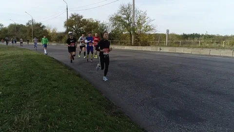 Athletes running a half marathon on an empty road Stock Footage 101792511