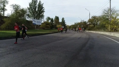 Athletes running a half marathon on an empty road Stock Footage 101792548