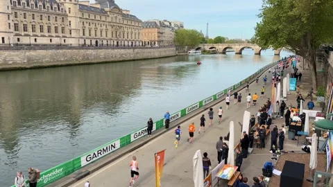 Athletes running the Paris marathon along the Seine river Stock Footage 336636588