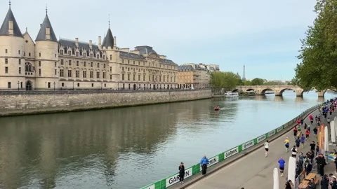 Athletes running the Paris Marathon along the Seine river Stock Footage 337024617