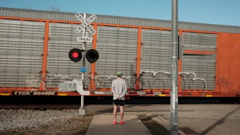 Athletes by train crossing waiting Stock Footage 232900558